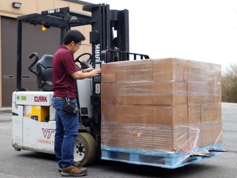 Image 1 Yu Yang attaching sensors to a forklift