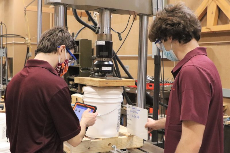 Image 1: Jordan Wells & Cameron Fischi conducting pail compression strength tests. 