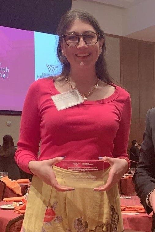 Image 1. Mary Paz Alvarez holding her award Image 2. Mary Paz Alvarez holding her award