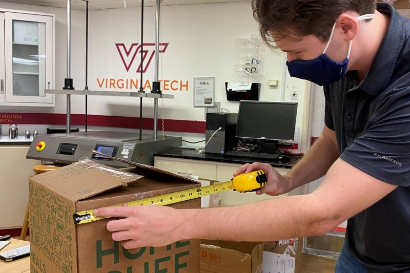 Image 1. Mark Brumnbaugh measuring a Home Chef meal kit box. Image 1. Mark Brumnbaugh measuring a Home Chef meal kit box.