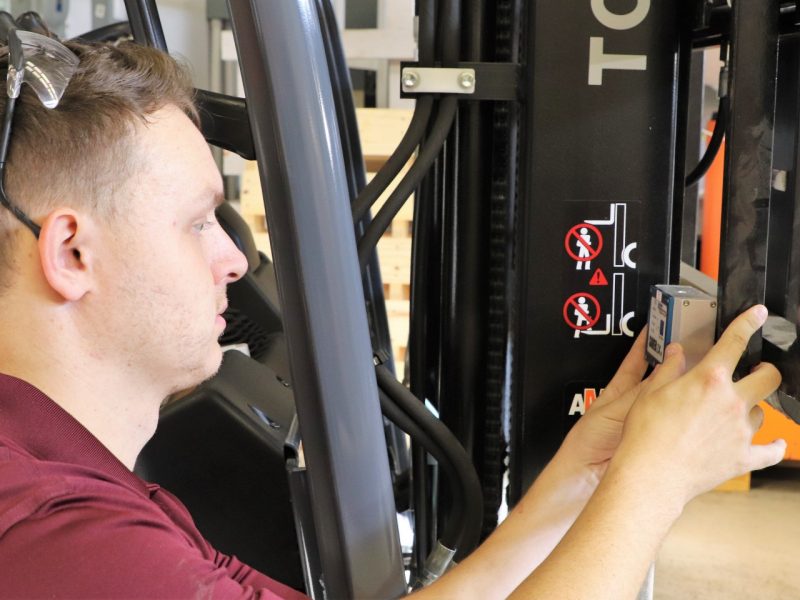 Image 1. Clark Sabattus equipping a forklift with a sensor to measure the shock events experienced in various warehouse facilities.