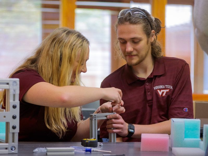 Students Morgan Bright, left, and Kyle Main construct a metal frame that will eventually house an accelerometer sensor. Collegiate Assistant Professor Eduardo Molina and a group of his undergraduate students are investigating the hazards that grocery packages experience during last-mile delivery to customers by designing and constructing instrumented packages and sending them through the supply chain.